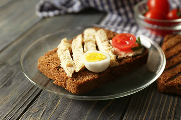 Plate with delicious toast on wooden table, closeup