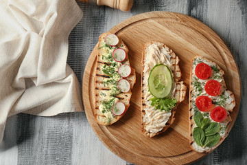 Delicious toasts on wooden table