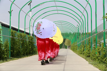 Women in cheongsam are walking