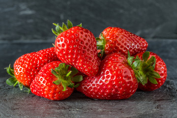 Fresh summer strawberries on a dark background