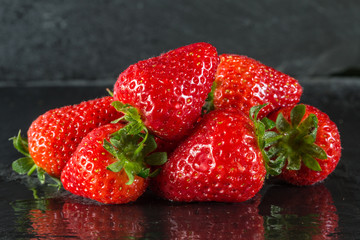 Fresh summer strawberries on a dark background