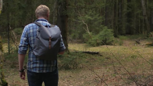 man with phone in a wild forest