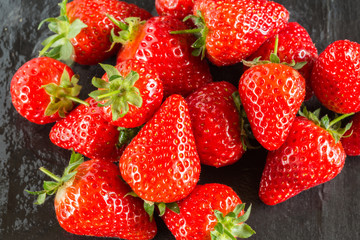 Fresh summer strawberries on a dark background