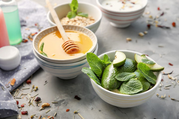 Bowls with natural ingredients for homemade cosmetics on table