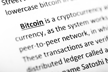 Bitcoin explanation or description in dictionary or article. Close up with focus on bitcoin....