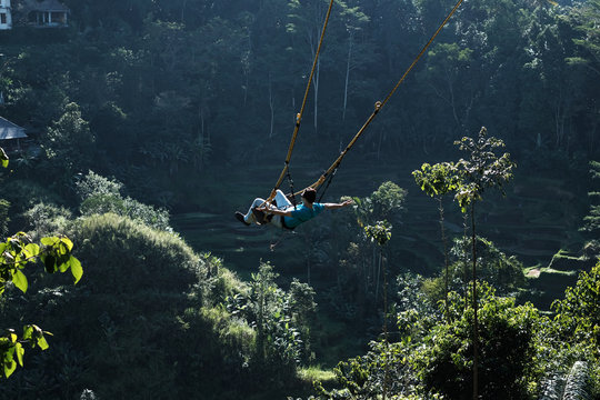 A Man Happily Swing At Ubud Bali Indonesia