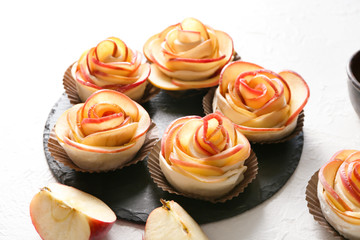 Raw rose shaped apple pastry on slate plate