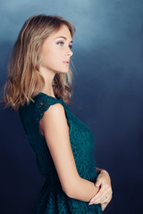 Fototapeta premium Beautiful Young Woman on Blue Background