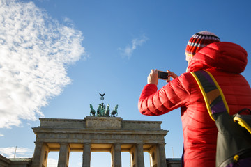 Tourist photographing Brandenburg gate, Berlin