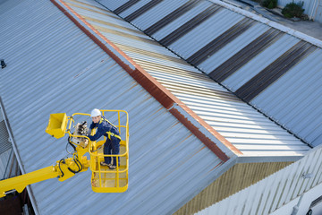 Woman elevated in crane bucket