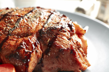 Tasty grilled steak on plate, closeup