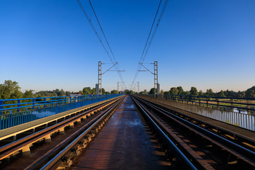 Fototapeta na wymiar The railway bridge in summer morning