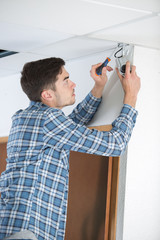 man installing cctv camera on the corner