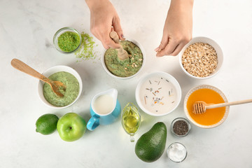 Woman making nourishing mask with avocado