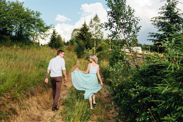Couple in love walking in the mountains, having fun