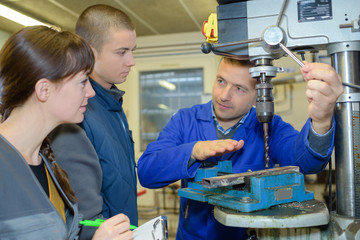 apprentices working on the machine - metal processing
