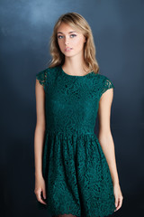 Young woman fashion model wearing green dress, portrait