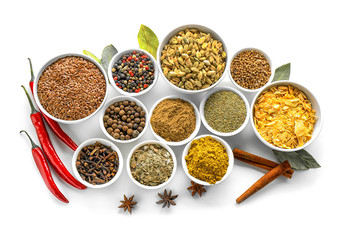 Bowls with various spices on white background