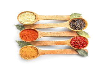 Wooden spoons with various spices on white background