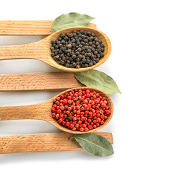 Wooden spoons with spices on white background