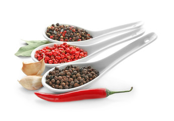 Spoons with various spices on white background
