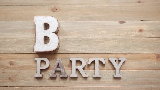 Metal BBQ Party sign with grilling tools on wood background