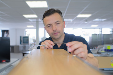 repairer working with screwdriver in service center
