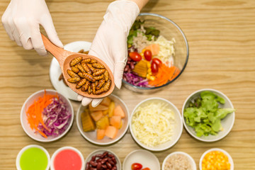 Fresh vegetable salad with worm insects