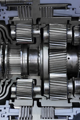 Gear box cross section, engine industry, sprockets, cogwheels and bearings of automotive transmission for oversize trucks and construction vehicles, selective focus 
