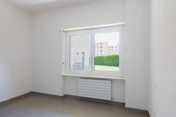 Fototapeta na wymiar Empty room with window and totally white walls