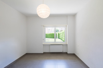 Empty room with window and totally white walls
