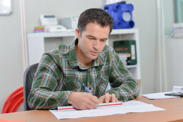 Architect sat drawing at his desk