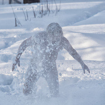 Portrait of a bearded naked man in the snow