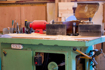 Carpenter tools on wooden table with sawdust