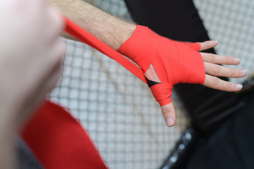 male puts on boxing bandages