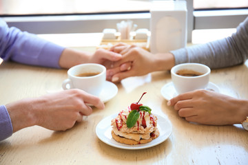 Happy couple having romantic date in cafe