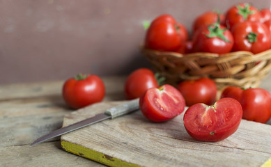 Fresh, red tomatoes on old wooden background