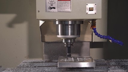Metalworking at the factory. The computer-controlled machine cuts the part out of aluminum. Machine with program control 4k