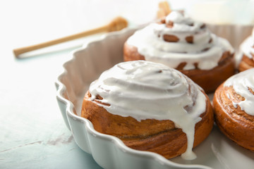 Dish with glazed cinnamon buns, closeup