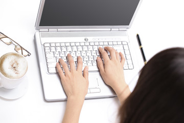 closeup.young woman typing text on laptop keyboard