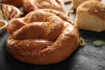 Sweet cinnamon bun on table, closeup