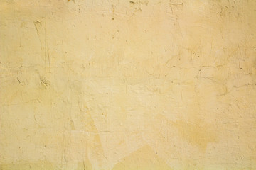 Texture of the old building wall with scratches, smudges and cracked paint.