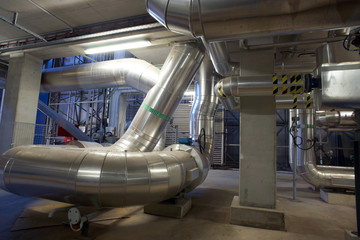 Obraz premium Equipment, cables and piping as found inside of a modern industrial power plant. Industrial zone, Steel pipelines, valves, cables and walkways