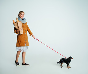 Young Woman Fashion Model Walking with Puppy Dog