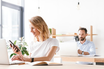 Smiling woman manager working with laptop computer