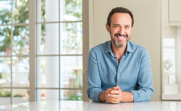 Handsome middle age man with a happy face standing and smiling with a confident smile showing teeth