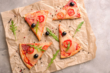 Slices of delicious pizza on grey textured background