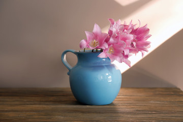Vase with beautiful tulips on wooden table