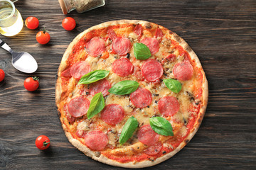 Tasty Italian pizza on wooden table