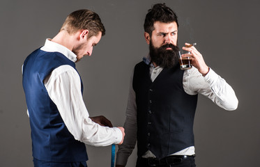 Client with beard and strict face smoke cigar and drink
